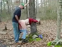 Redneck slut, tied to a tree in the forest, gets doggystyle fucked.