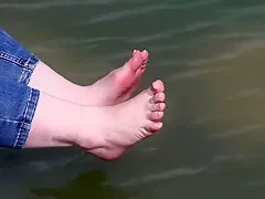 the feet of a mature lady on stones
