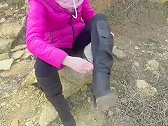 Girl sprains her ankle in high heeled knee boots on beach, bandages ankle