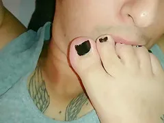 Giving a footjob while my footslave is licking my feet and toes.