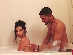 Handsome fella worships his sexy girlfriends feet and legs in the bathtub