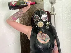Dominatrix Nika In A Gas Mask Pours Wine Over Her Latex Body. Latex Fetish